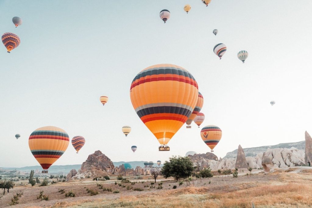 Watching Cappadocia hot air balloons from panoramic viewpoints at sunrise