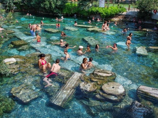 Visitors bathing in the thermal waters of Hierapolis.