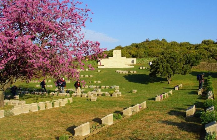 Peaceful Anzac Cove cemetery with trees, flowers and walking path in Gallipoli, Turkey