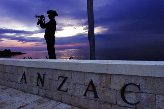 Bugler silhouetted at sunrise playing during Anzac Day dawn service at Gallipoli memorial