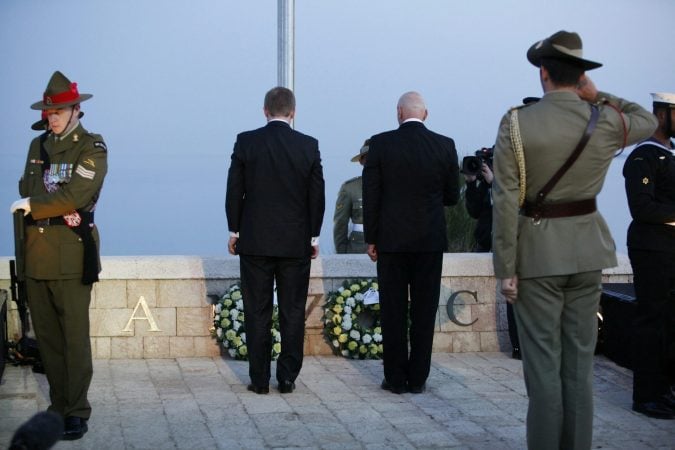 Soldiers and officials standing at Anzac Day wreath-laying ceremony at Gallipoli memorial
