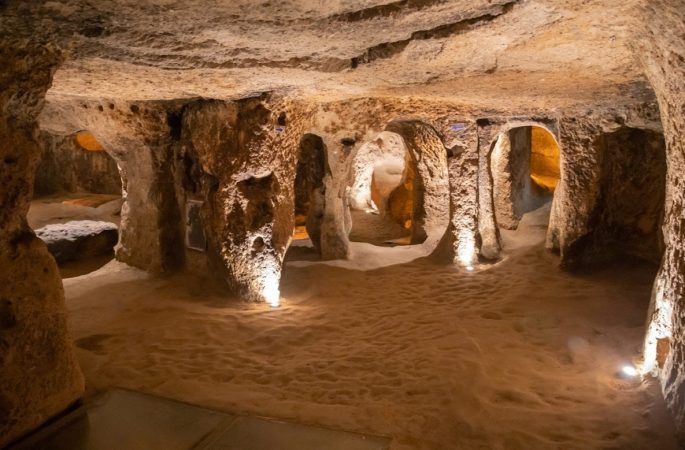 Large carved hall with interconnected chambers inside Derinkuyu Underground City, Cappadocia.
