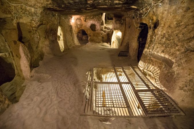 Wooden walkway through narrow passages inside Kaymakli Underground City, Cappadocia, Turkey.