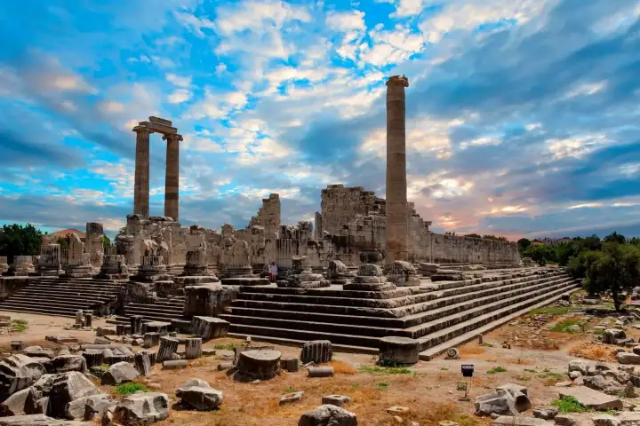 Ruins of the Temple of Apollo in Didyma beneath a dramatic evening sky