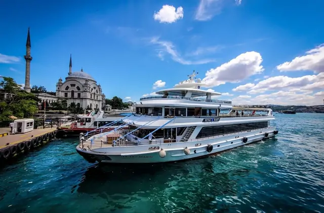 A luxury yacht cruises on the Bosphorus in Istanbul under a clear sky, reflecting the elegant side of private boat experiences on this world-renowned waterway.