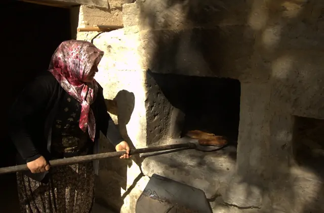 Preparación tradicional de pan en horno durante una clase de cocina en Capadocia