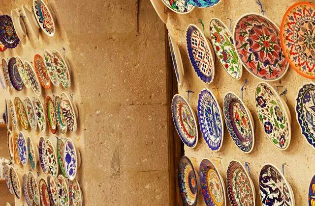 Stacked terracotta amphoras and storage jars reminiscent of ancient Hittite designs outside an Avanos pottery store, a key Red Tour stop in Cappadocia.