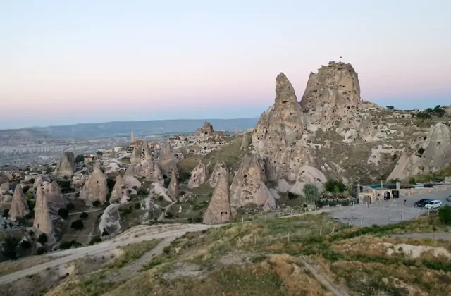 Interior tunnel corridor inside Üçhisar Castle with a glimpse of Cappadocia landscape through a carved window opening, a feature of the Red Tour visit.