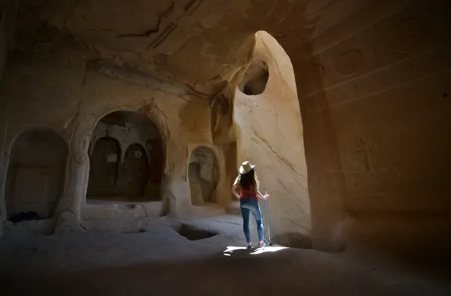 A narrow carved corridor connecting cave rooms in the Zelve valley complex, offering a glimpse of everyday life in ancient Cappadocia on the Red Tour.