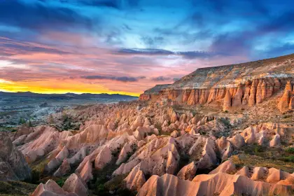 Winding footpath through Güllüdere Rose Valley, Cappadocia, with towering pink tuff walls on either side creating a natural corridor explored during the Cappadocia Yellow Tour.