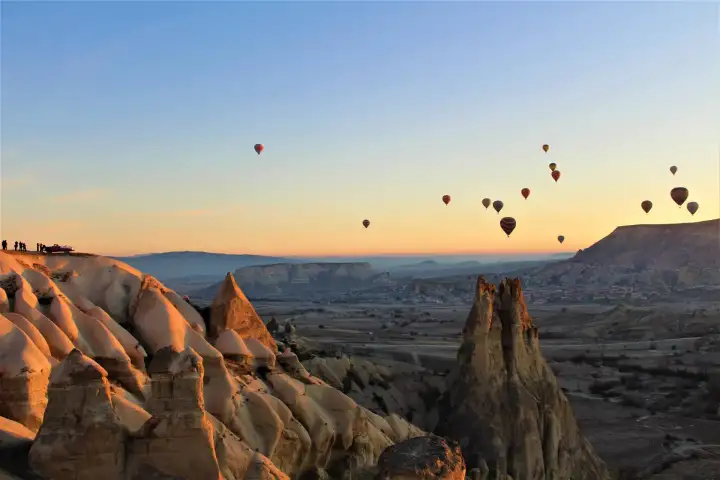 View across Pigeon Valley toward the volcanic cone formations in Cappadocia, with the characteristic honeycombed cliff walls visible from the Yellow Tour observation deck.