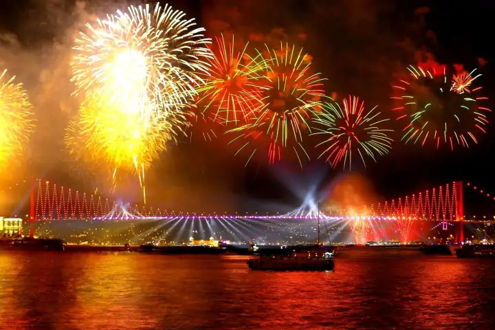 Crucero de fiesta de Año Nuevo en Estambul por el Bósforo con invitados celebrando la Nochevieja al estilo turco frente al brillante horizonte de la ciudad. Una espectacular experiencia de fiesta de Nochevieja navegando entre Europa y Asia.